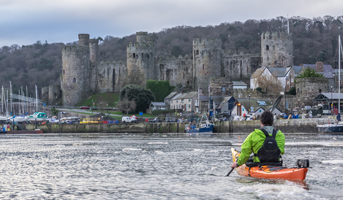 Riot Brittany paddling past Conway Castle